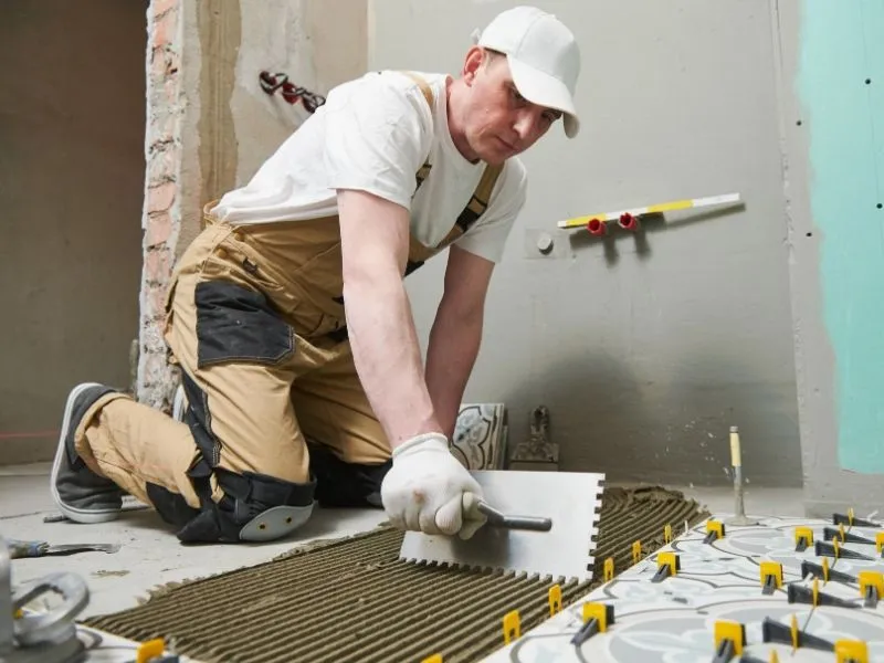 Professional tiler at work on an interior tiling project