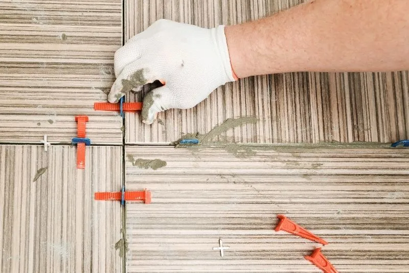 Tiler installing bathroom tiles during a Noosa renovation