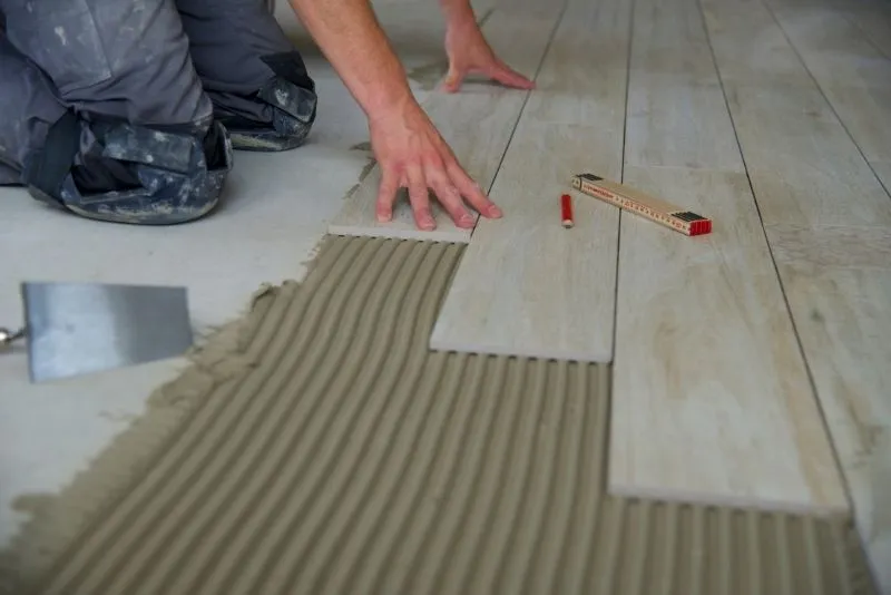 Professional tiler installing indoor floor tiles in Noosa