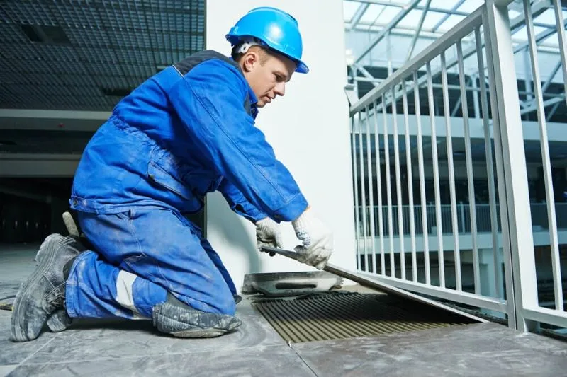 Tiler installing a tile on a commercial shopping mall in Sunshine Coast