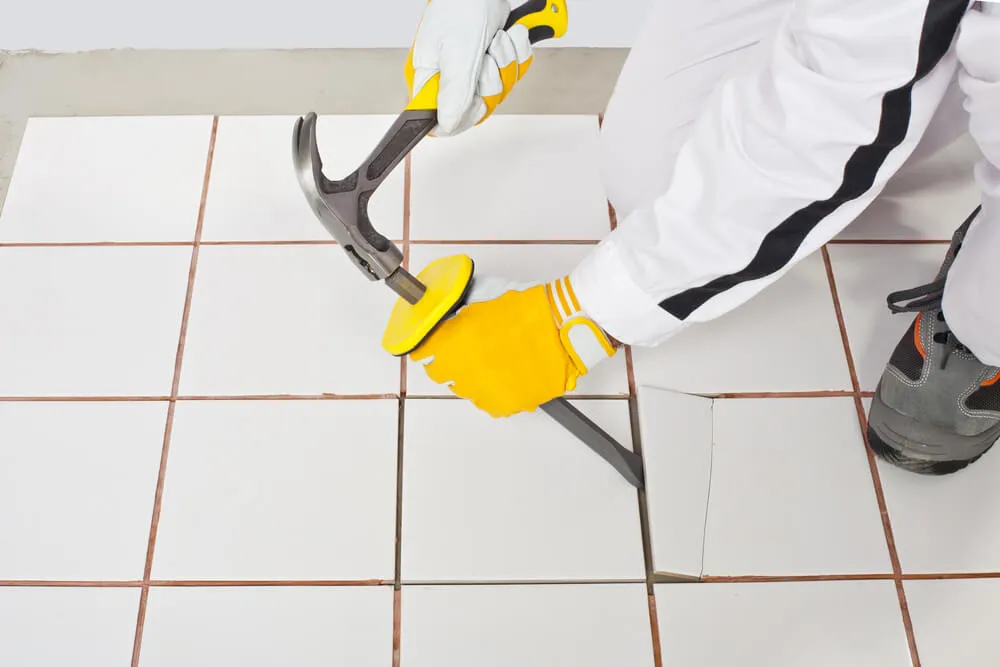 Exterior Tiles removal contractor chiseling floor tiles