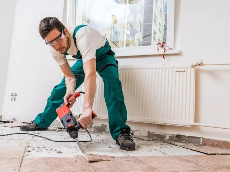 Tiler jackhammering old floor tiles on a Sunshine Coast job