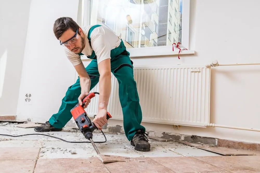 Tiler jackhammering old floor tiles on a Sunshine Coast job
